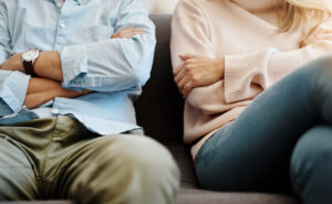 Tense couple has a conversation on a couch