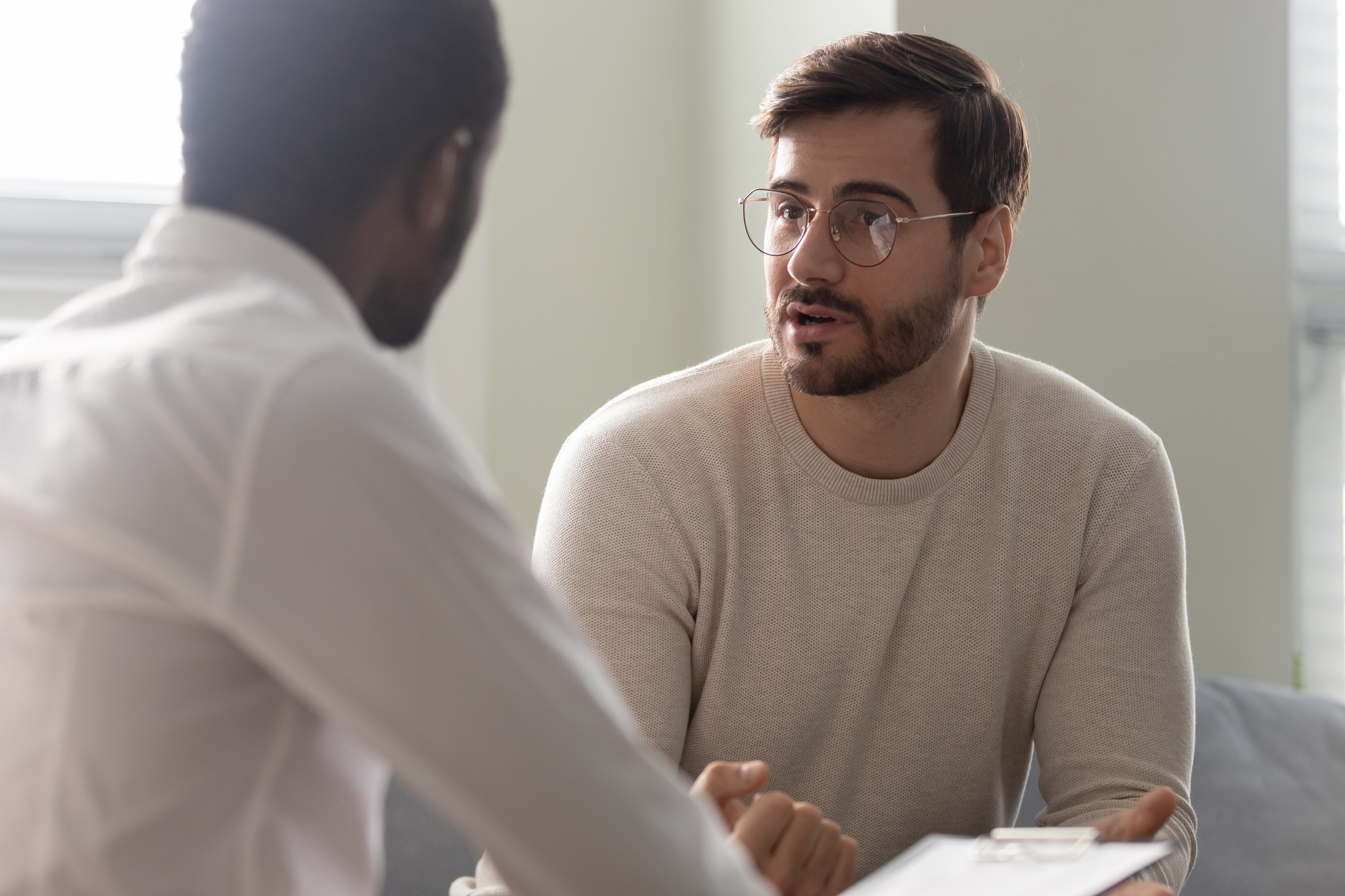 Psychologist speaks with a client